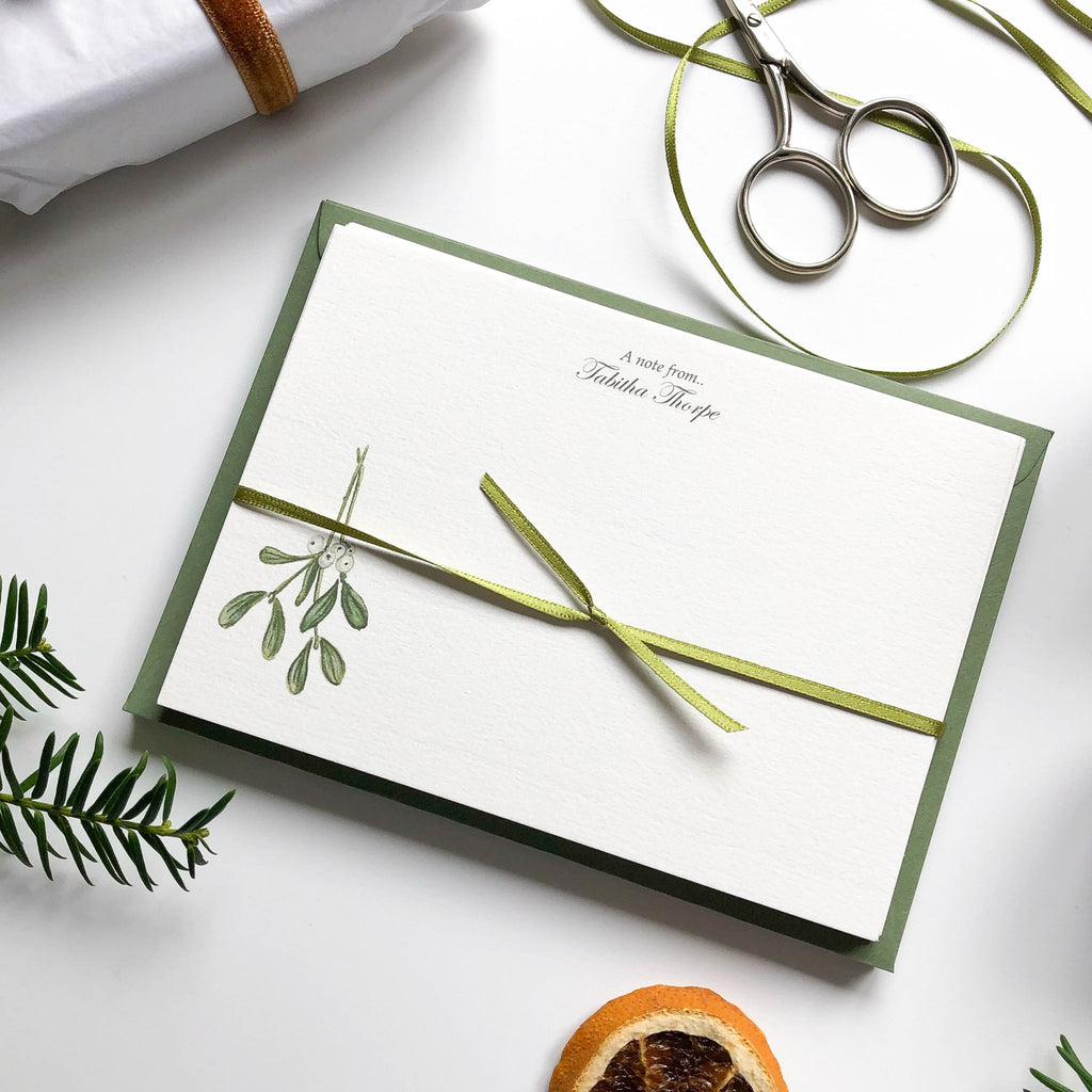 personalised christmas mistletoe foliage flat notecards wrapped in ribbon with scissors & orange slice