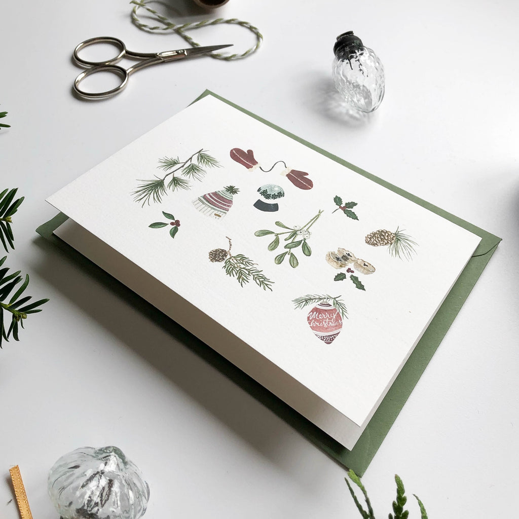 hand illustrated warm & cosy christmas card with green envelope close up